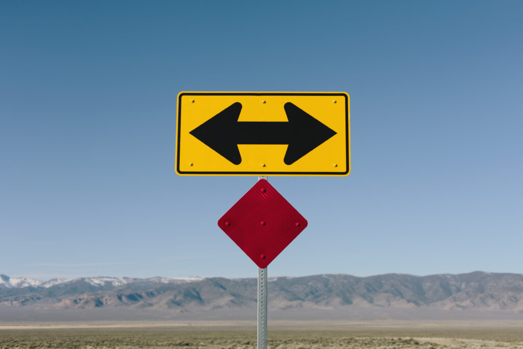 A crossroads sign with arrows pointing left and right, symbolizing the fear of change and the decisions faced in recovery.