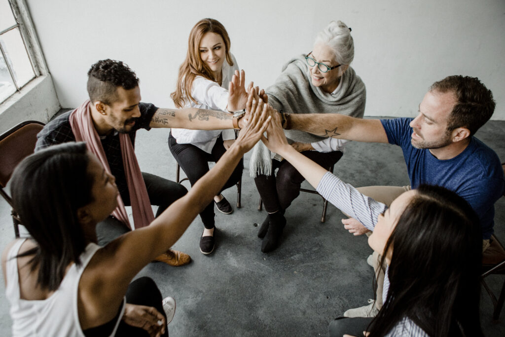 A supportive group therapy session, representing the connection and community offered through supportive care programs like IOP and PHP.