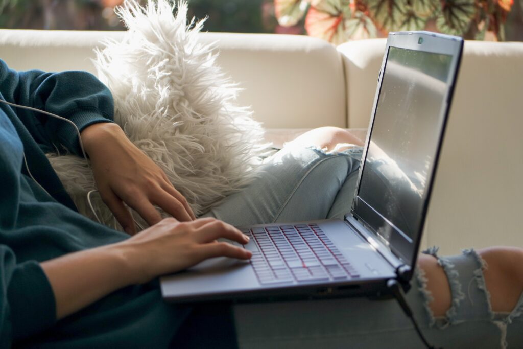 A person attending a virtual therapy session on a laptop from the comfort of home, highlighting the accessibility of supportive care.