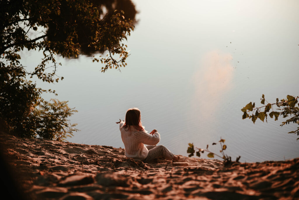 A person journaling and meditating in a peaceful setting, demonstrating mindful strategies to improve social media and mental health.